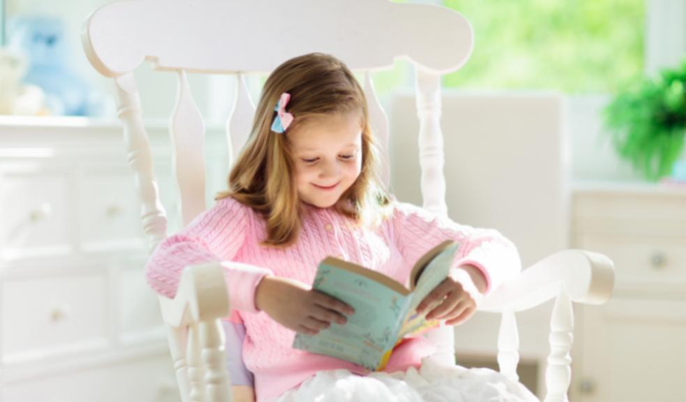 picture of a happy child reading a book