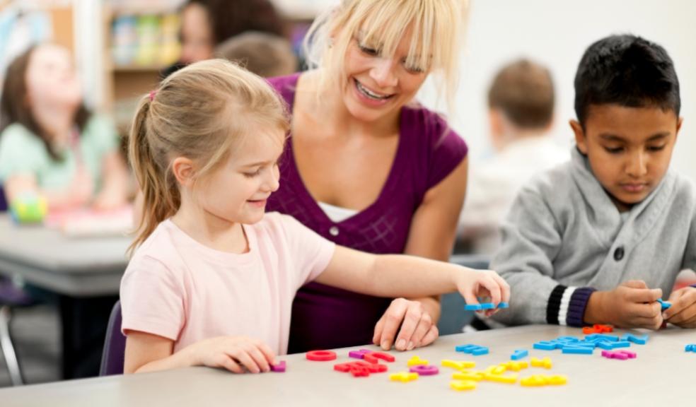 picture of childcare worker and children in a daycare setting 