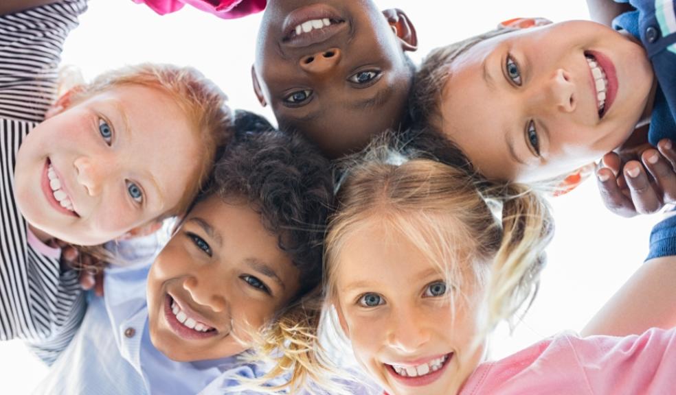 picture of happy children with their heads together in a circle