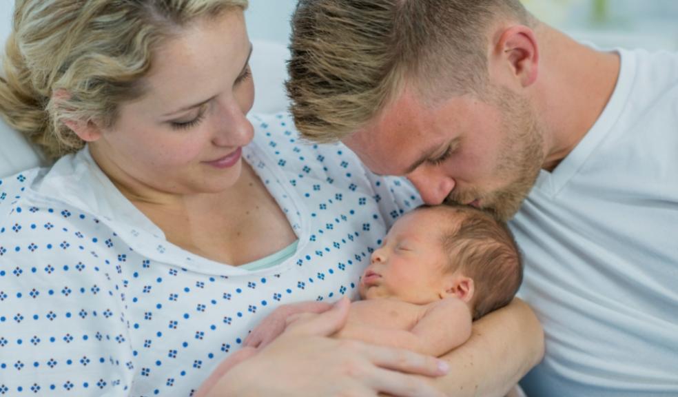 picture of new parents with a new baby