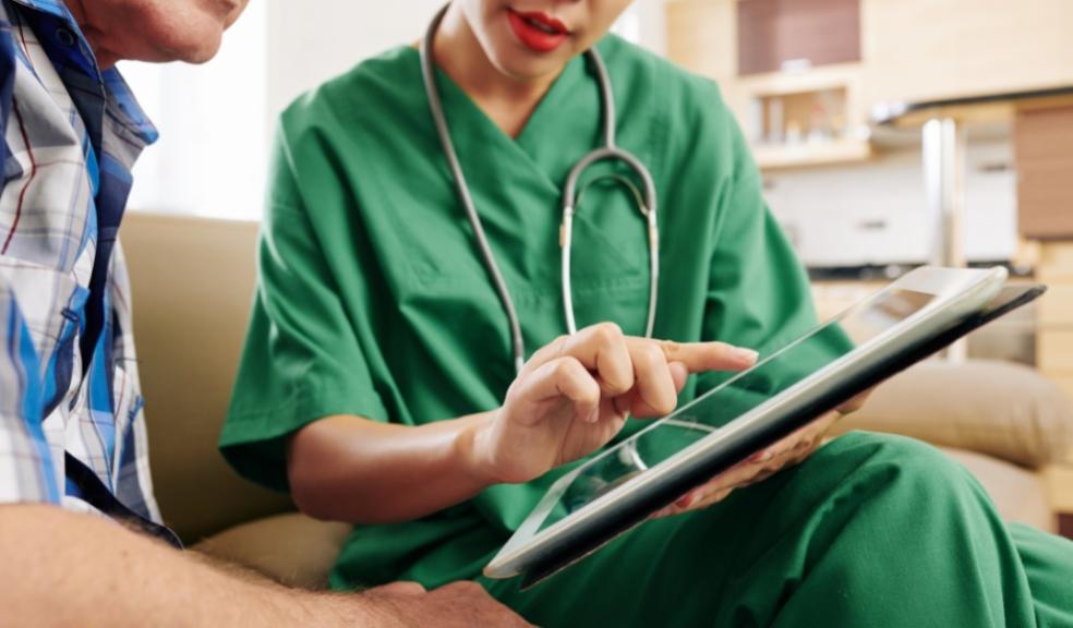picture of health professional showing patient an app