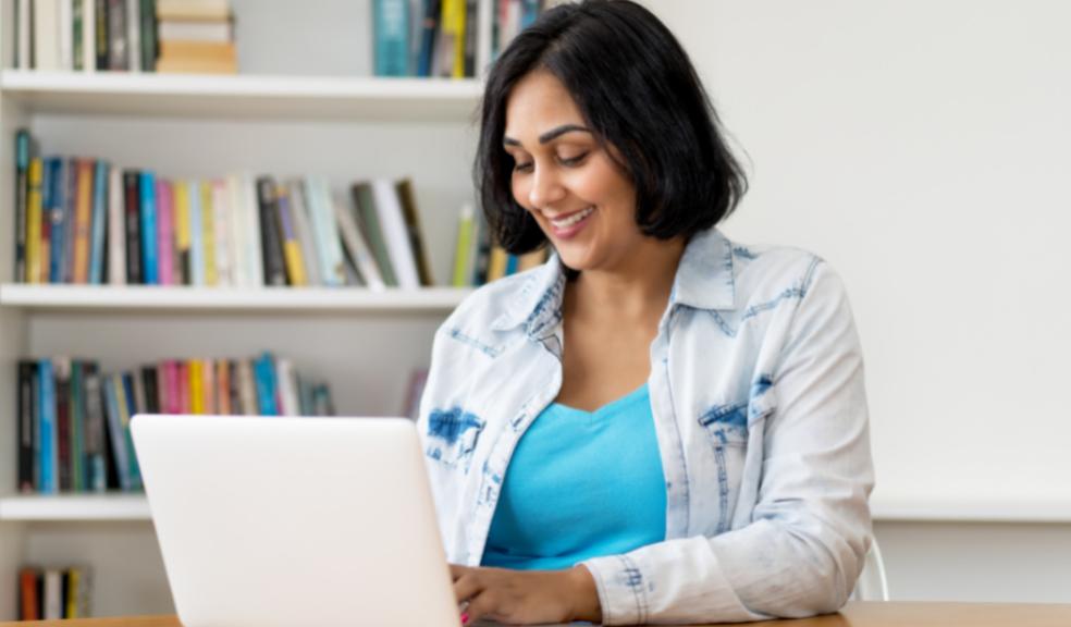 picture of happy mexican woman on a laptop computer