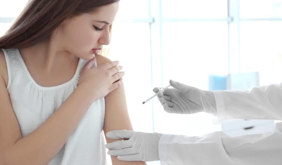 picture of a teenage girl getting a vaccination