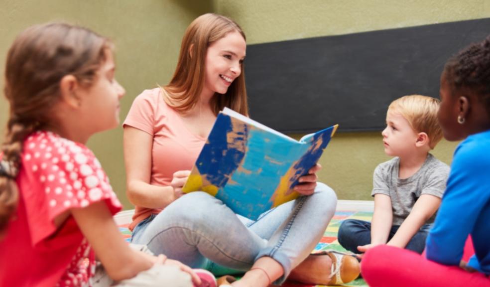 picture of a teacher or childminder reading children a story