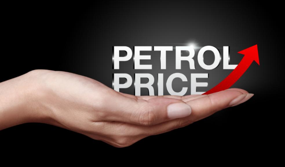 picture of a hand holding the words petrol price and a red arrow pointing up