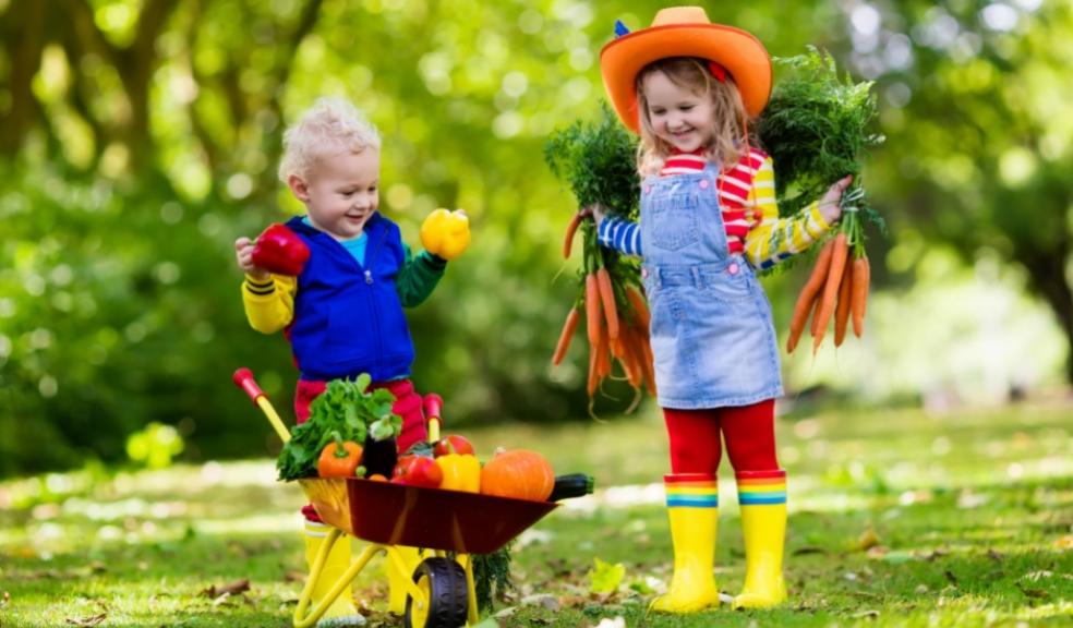 picture of happy children outside gardening