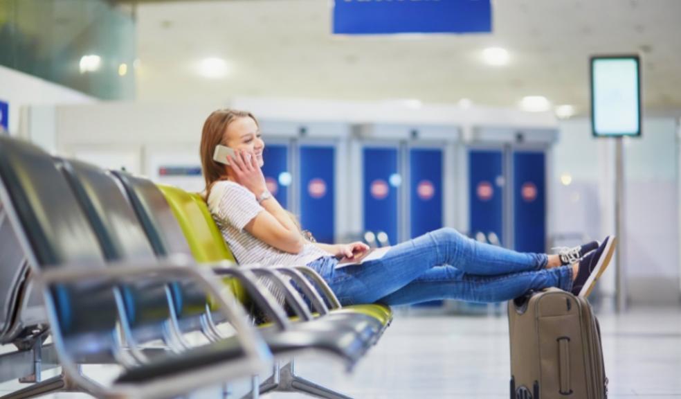 picture of a woman on her phone at an airport