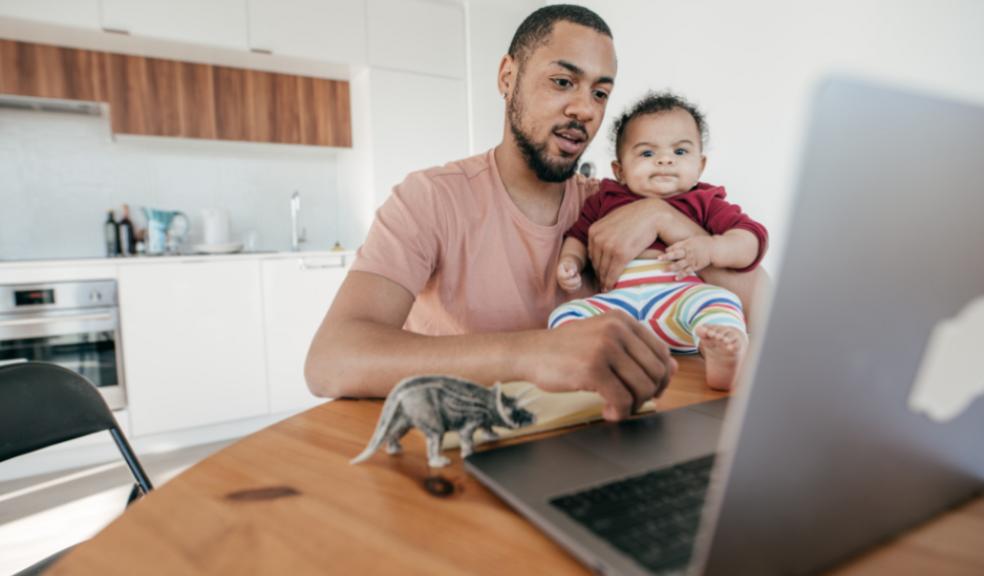 picture of a dad with his baby on his lap on a laptop