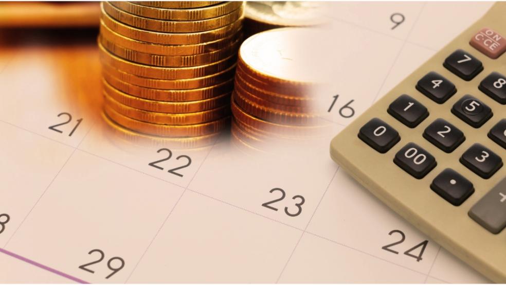 picture of money and calculator on a calendar 