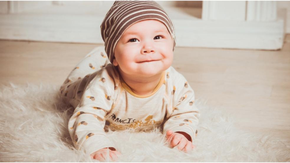 picture of neutral baby laying on a rug