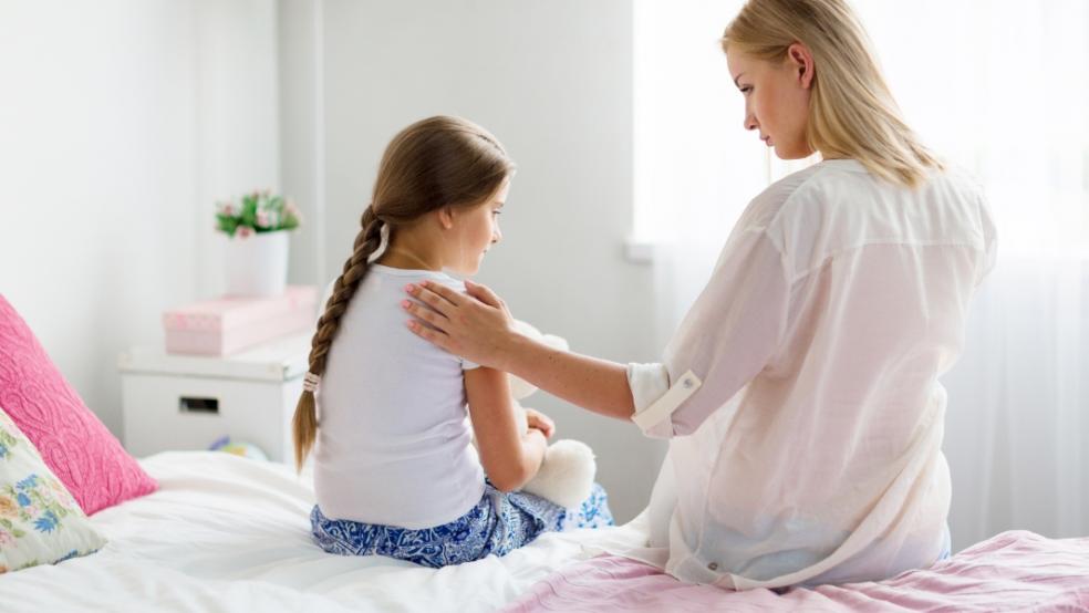 picture of parent comforting a grieving child