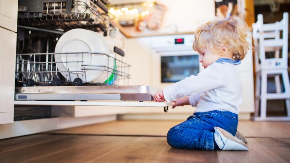 picture of a child looking in a dishwasher