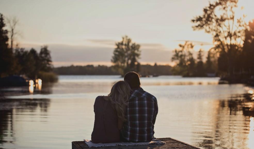 picture of an isolated couple looking out over water