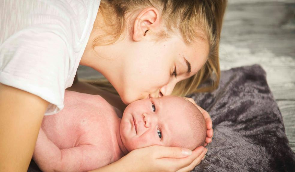 woman kissing baby