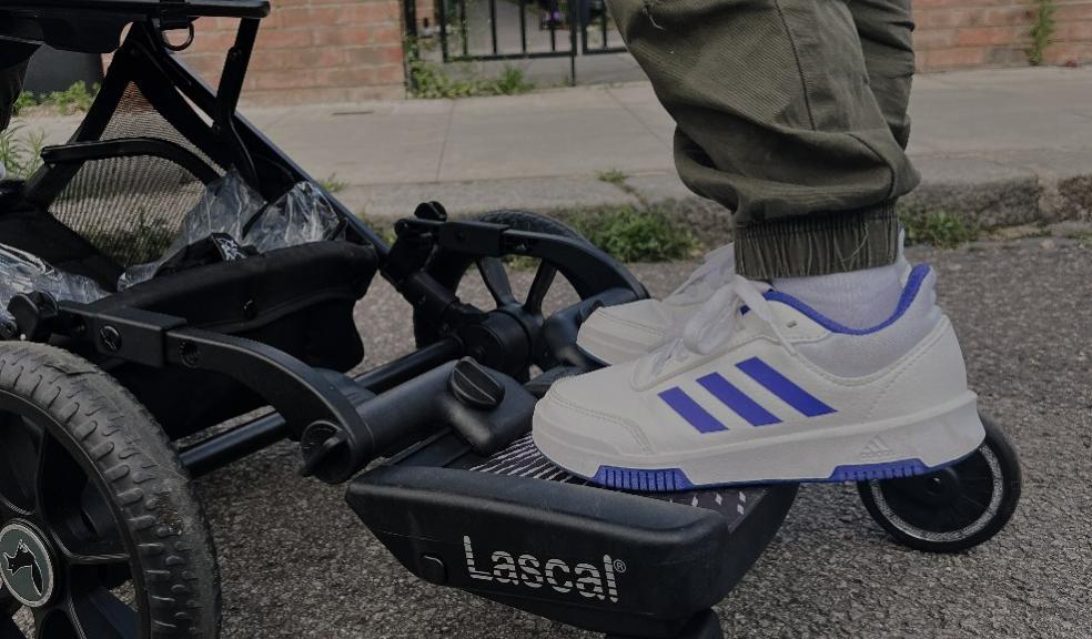 a child standing on a Lascal buggy board attached to a pram picture of a child standing on a Lascal buggy board attached to a pram