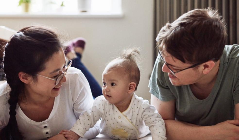 picture of a baby doing tummy time with parents
