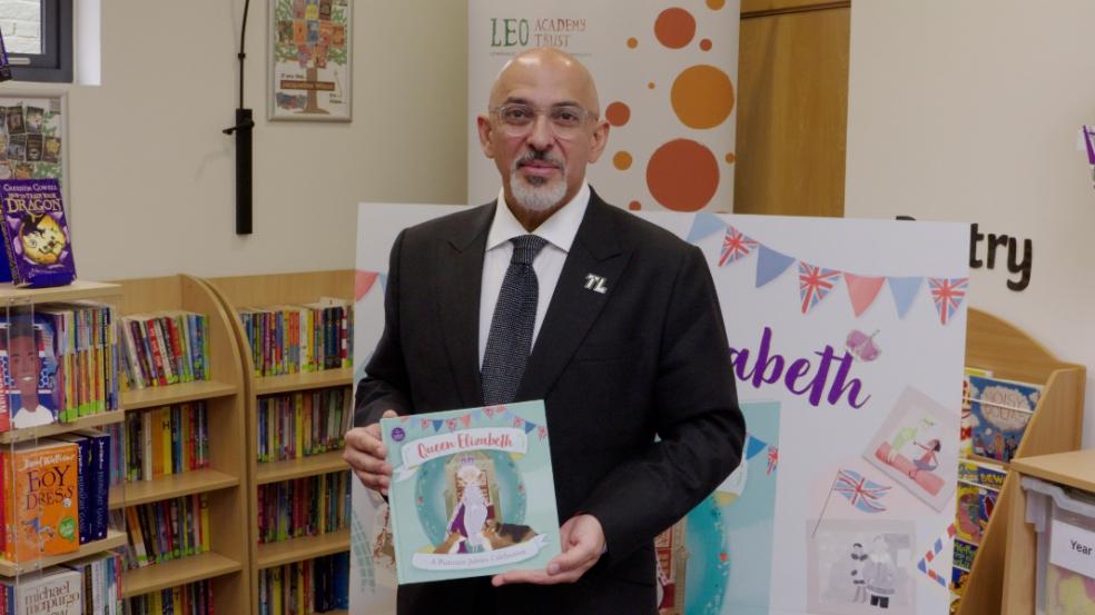 picture of Nadhim zahawi giving out free books to school children
