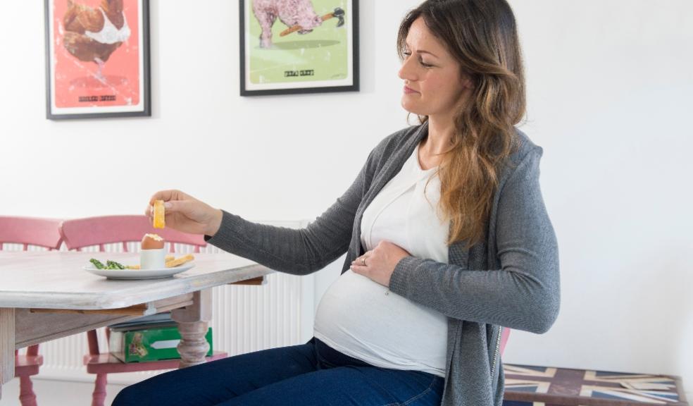 a pregnant woman eating British Lion boiled eggs to aid healthy brain picture of a pregnant woman eating British Lion boiled eggs to aid healthy brain