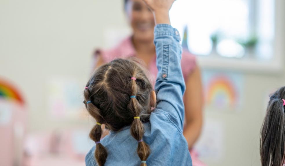 picture of a child putting her hand to to ask a question