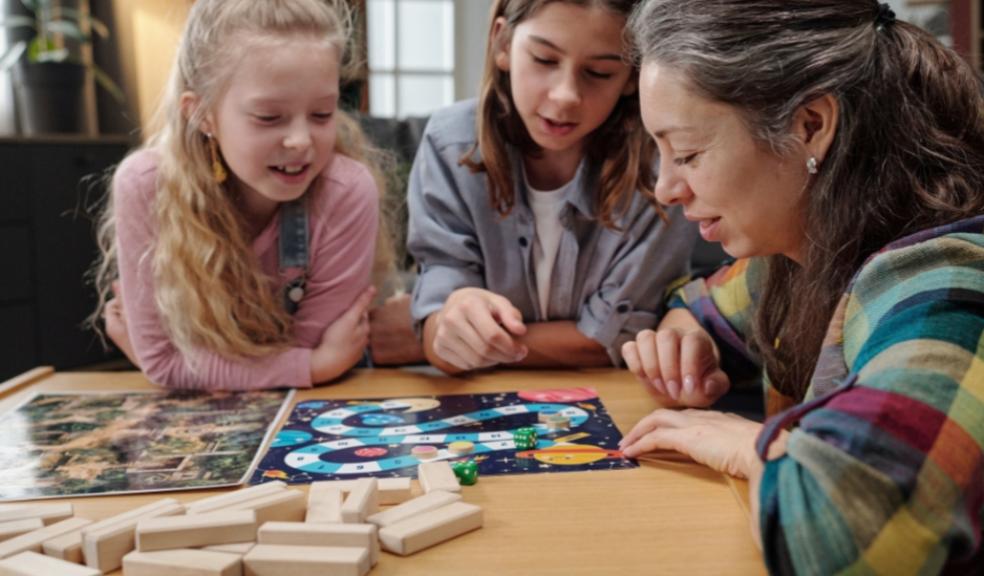 a family playing a board game to have screen free fun picture of a family playing a board game to have screen free fun
