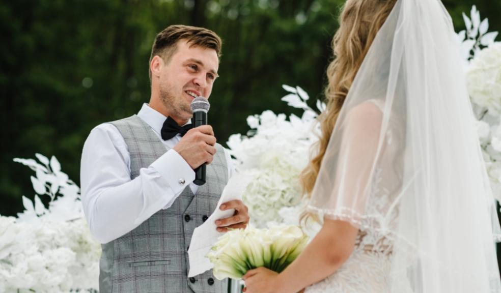 picture of a groom giving a speech to his wife on their wedding day