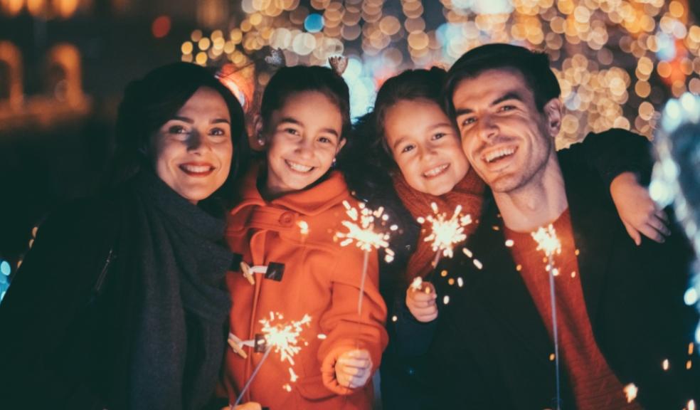 a happy family holding sparklers celebrating New Years Eve together picture of a happy family holding sparklers celebrating New Years Eve together