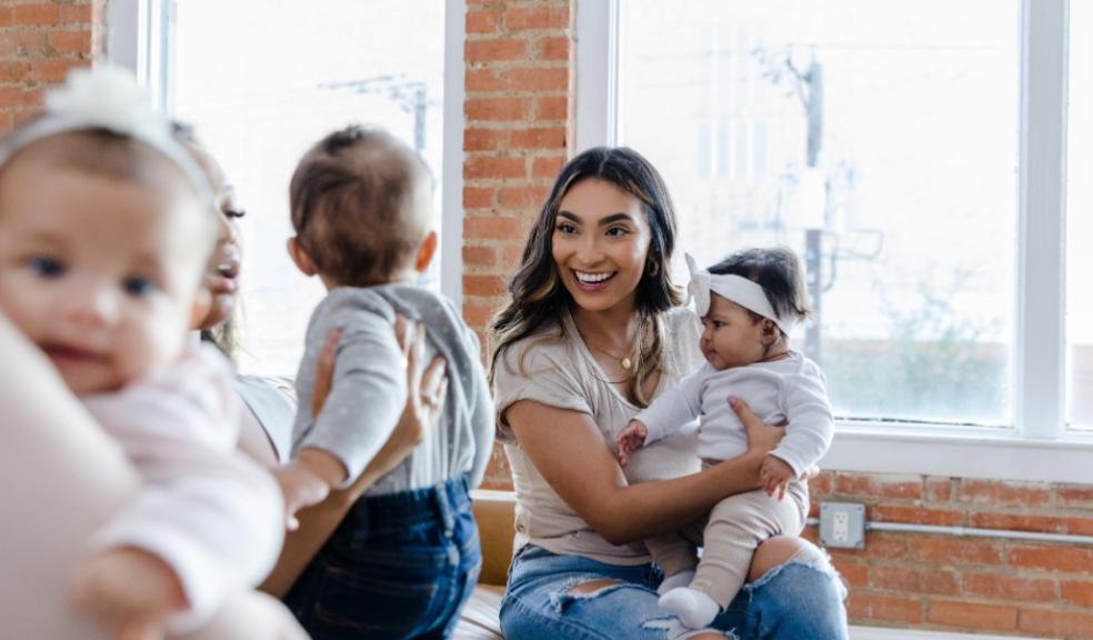a happy mum and baby interacting at a mother and baby group picture of a happy mum and baby interacting at a mother and baby group