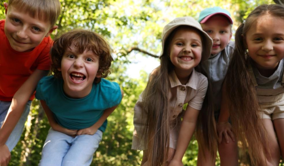 happy children in a forest enjoying a walk in nature picture of happy children in a forest enjoying a walk in nature