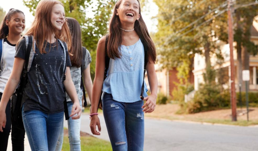 happy teenagers walking down the street thinking about their futures picture of happy teenagers walking down the street thinking about their futures
