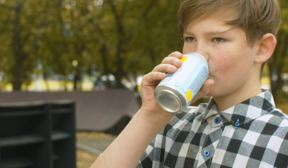 picture of a child drinking a can of energy drink