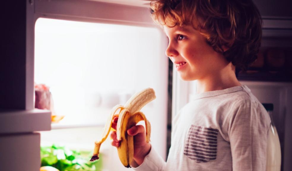 picture of a child eating a banana as a bedtime snack