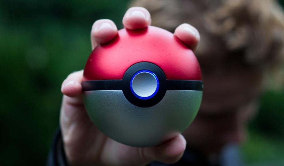 child holding a pokemon ball picture of a child holding a pokemon ball