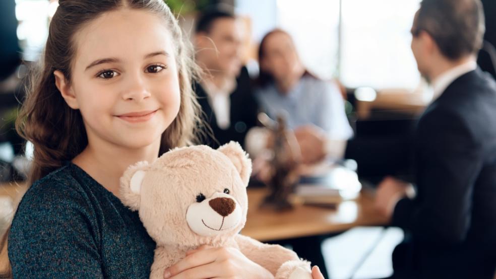 picture of a child holding a teddy in a family lawyers office