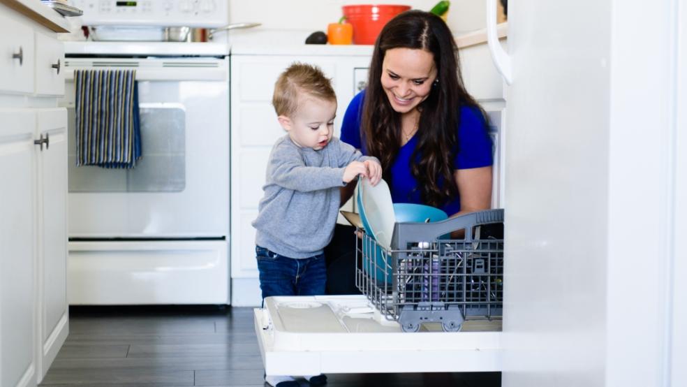 picture of a child loading the dishwasher