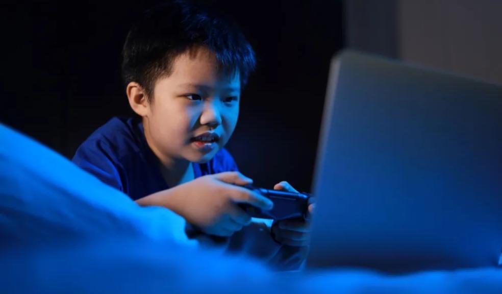 picture of child on a device at bedtime