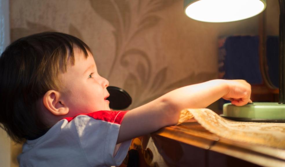 picture of a child turning on a desk lamp