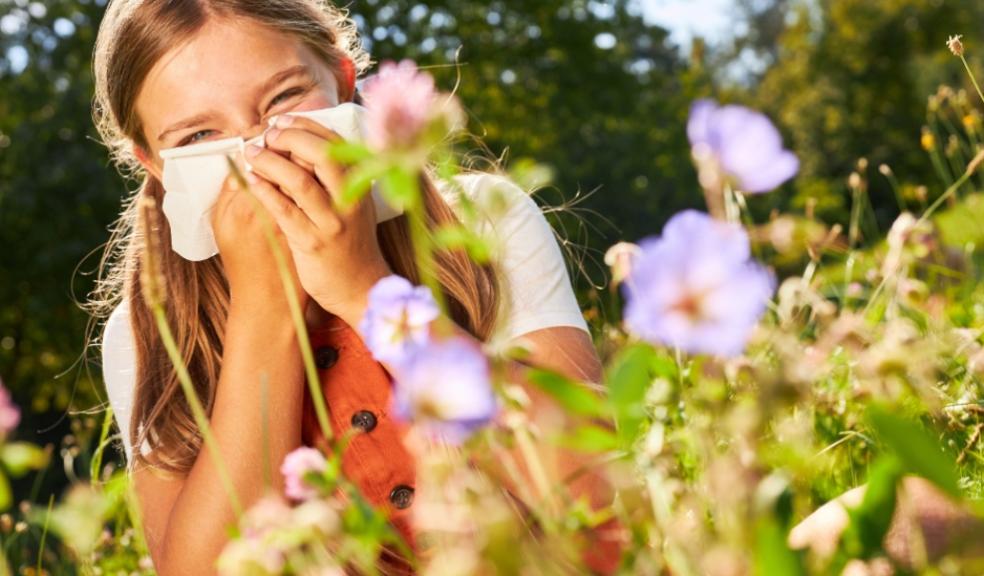 picture of a child with hayfever sneezing outside