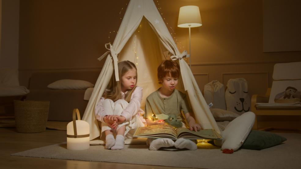 picture of children reading in a teepee
