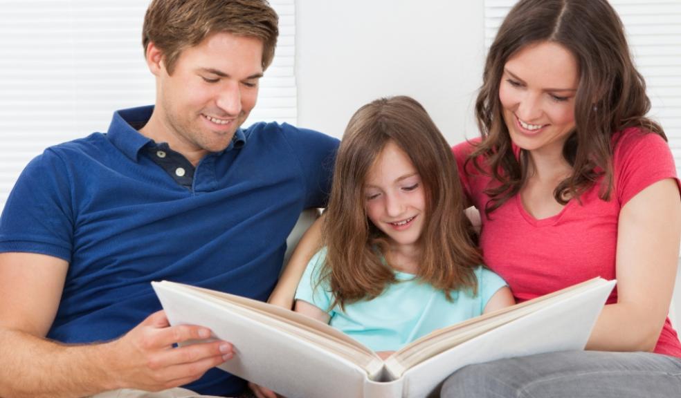 picture of a family looking at a photo album