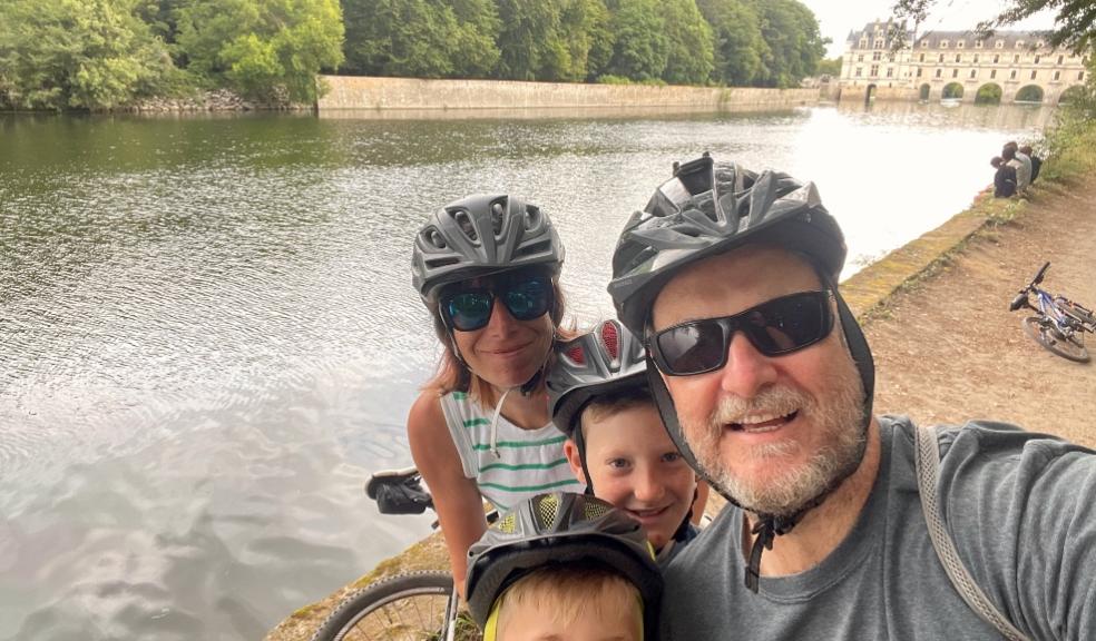 picture of a family on a cycling holiday by a river