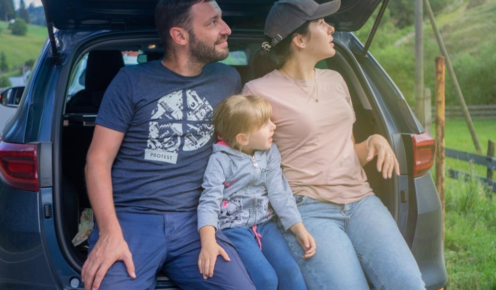 family sat in the back of a car picture of a family sat in the back of a car