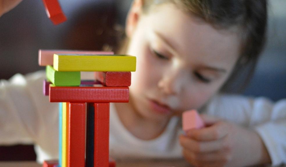 picture of a toddler building with building blocks