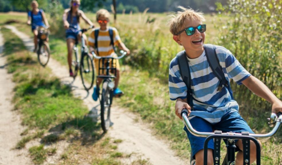 picture of a happy family riding bikes outside