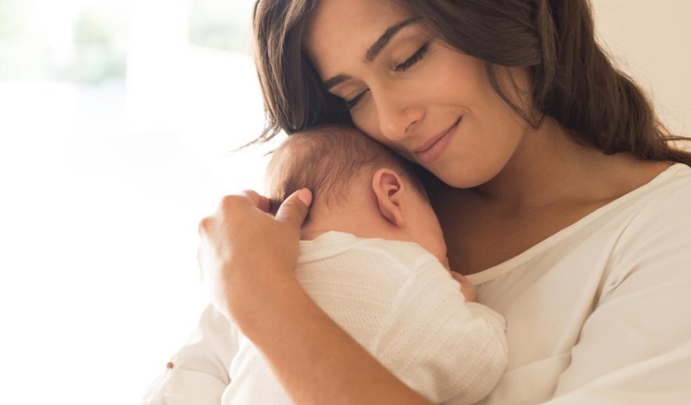 happy mum holding new baby picture of a happy mum holding new baby