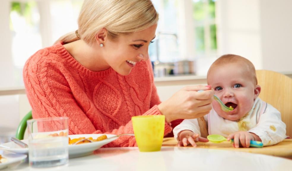 picture of a happy mum weaning her baby