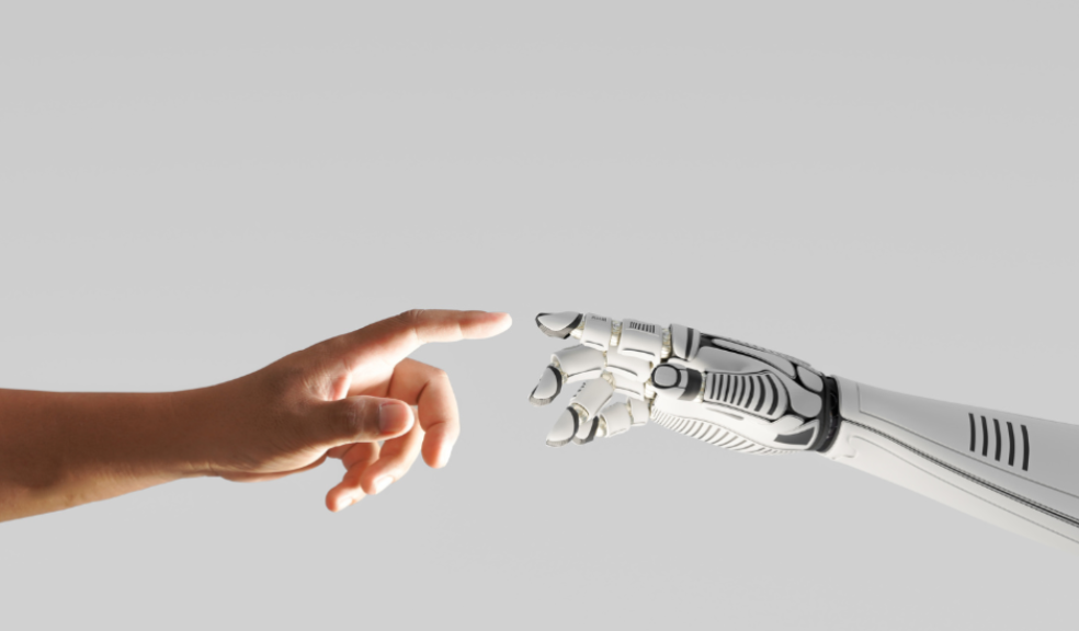 picture of a human hand touching a robotic hand