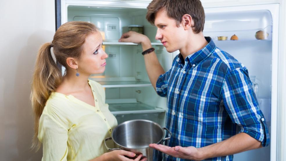 picture of hungry couple with empty fridge
