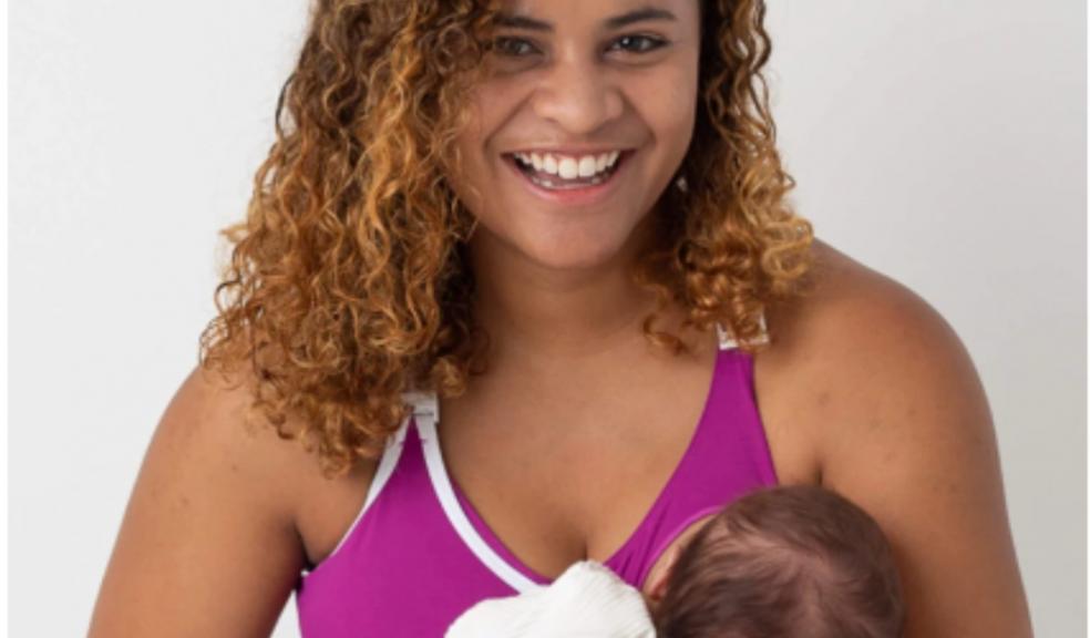 Picture of a mum breastfeeding wearing a latched nursing sports bra