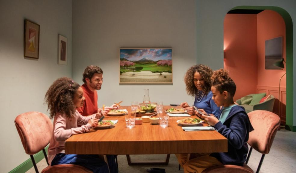 picture of a multi cultural family sitting down to eat dinner together
