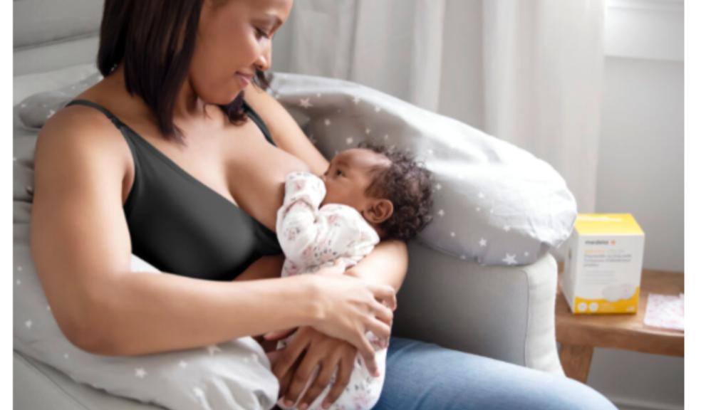 picture of mum breastfeeding her baby with some medela products